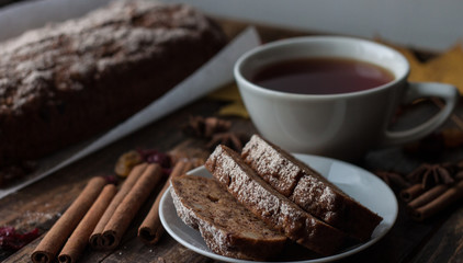 Homemade banana bread with anis star and cinnamon on a dark wooden background