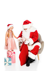 happy santa claus and little child petting piggy together isolated on white