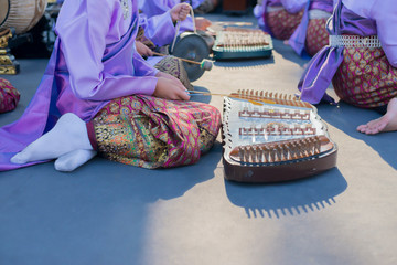 People who are playing traditional Asian music.