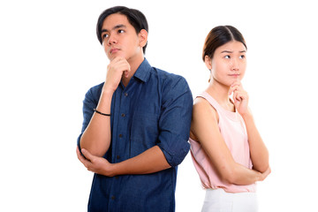 Young Asian couple thinking and looking up