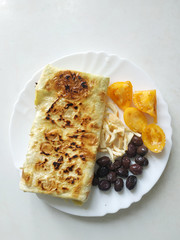 Cutted lavash pieces with vegetables. Burek with spinach and cheese and black cumin. Yufka
