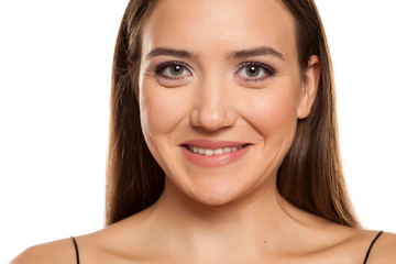 Obraz premium Portrait of young beautiful smiling girl on white background