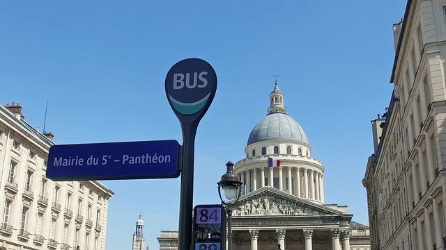 Pantheon with bus stop sign at day, Paris, France. It is a secular mausoleum containing the remains of distinguished French citizens.Located in the 5th arrondissement of Paris on the Mountain Saint Genevieve