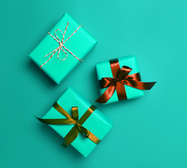 Christmas gift boxes on turquoise background.