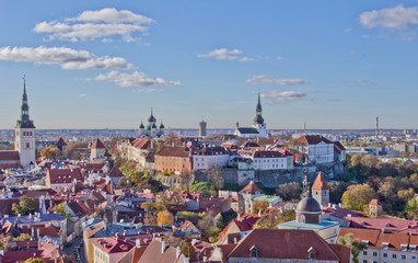 Naklejka na ściany i meble Scenic summer view of Tallinn Old Town, colorful Estonia in clear weather. colorful roofs of Tallinn. Aerial view of the city in the old town