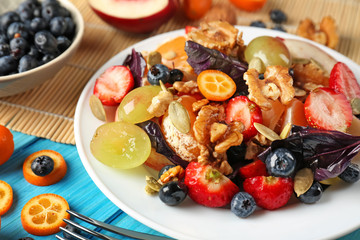 Delicious fresh salad with walnuts on plate