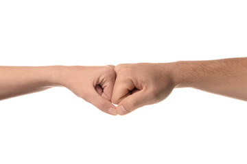 Man and woman making fist bump gesture on white background