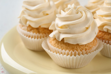 Delicious cupcakes on plate, closeup