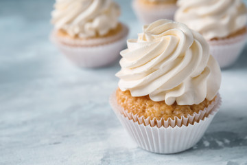 Delicious cupcake on grey table