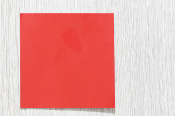empty red art paper on a white wooden floor.