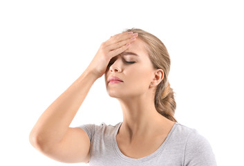 Fototapeta premium Young woman suffering from headache on white background