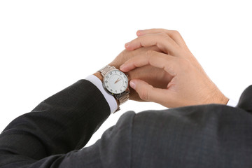 Young businessman looking at watch on white background, closeup