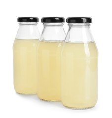 Bottles of fresh lemonade on white background