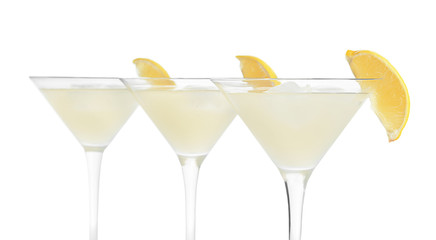 Glasses of fresh lemonade on white background