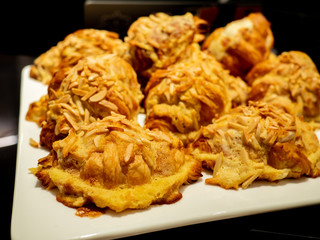 Assortment of delicious and buttery almond croissants filled with frangipane or sweet almond filling made by pastry chef. All look very tasty and delightful. Natural light.