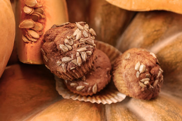 Tasty sweet muffins with pumpkins, closeup