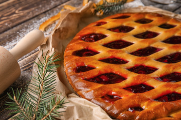 Tasty Christmas pie stuffed with cranberries on table, closeup