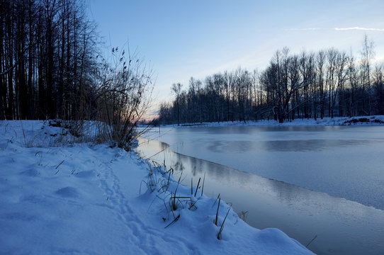 Winter's river in ice and shore in the snow