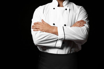 Male chef on dark background, closeup