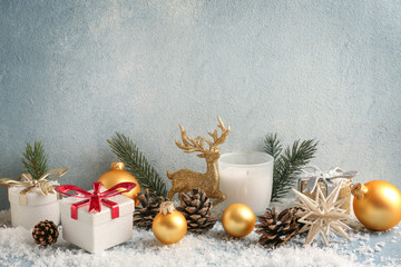 Beautiful Christmas decorations on table near light wall