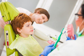 Dentist is teaching children about braces. 