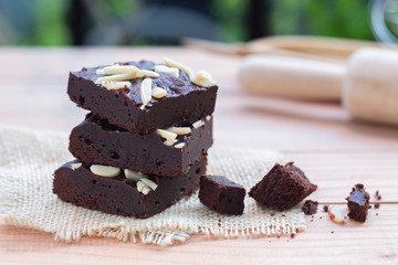 Stack of Dark chocolate brownies with almond topping.