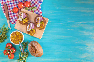 Sandwich with pieces of marinated herring with red onion and french mustard
