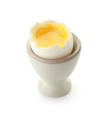 Boiled chicken egg in holder on white background