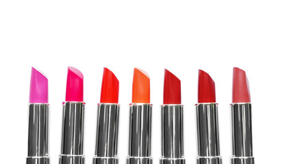 Different color lipsticks on white background