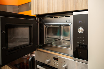 Fototapeta premium Photo of open microwave in kitchen