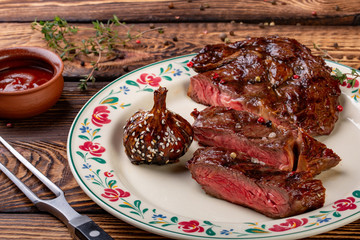 Fresh grilled meat. Grilled beef steak medium rare on wooden background