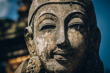 Fototapeta na wymiar Closeup portrait of Hindu Buddhist traditional stone sculpture. Bali, Indonesia