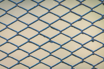 Fototapeta premium Diamond-shaped steel mesh fence close-up background