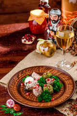 Georgian dish - phali of spinach and meat on a brown plate on a wooden background. close-up