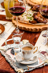 black coffee in a white cup on a silver tray