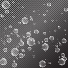 Realistic soap bubbles with rainbow reflection set isolated on the black transparent background.