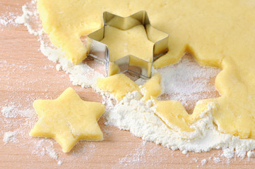 baking christmas star shape cookies. fresh dough.