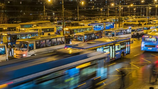 passengers waiting and boarding buses at the bus terminal, time lapse