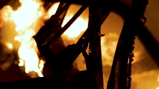 Burning car body, burning iron, broken car on fire