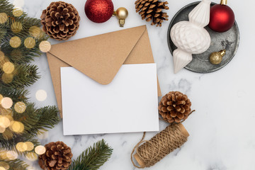 Blank white christmas card composition. Fir branch, festive seasonal decorations, lay flat...