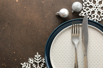 Christmas table setting. Knife, fork and plate with new year decorations. on a dark table. top view with space for an inscription. new Year. holidays