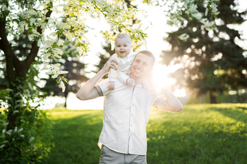 Fototapeta premium Dad and child together on nature in summer day