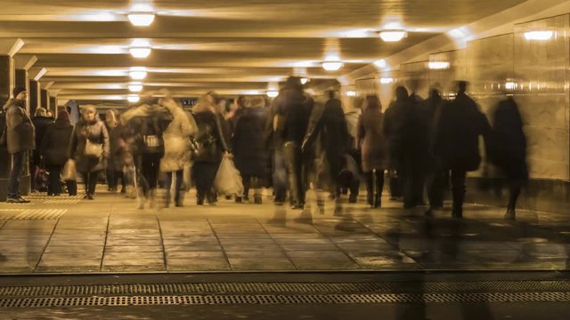 crowds of people moving through the underpass