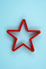 Obraz premium Cookie cutter star shape on light blue background