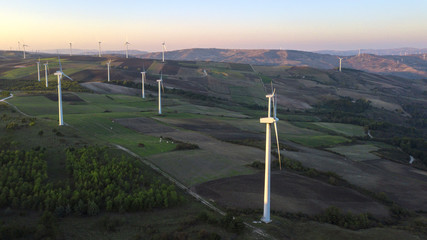Aerial view at sunset of Wind turbines for renewable sources of electricity without pollution....