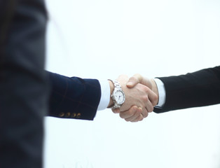 close up.business men shaking hands on blurred background office