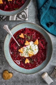 Overhead view of borscht beetroot soup with sour cream served in bowl