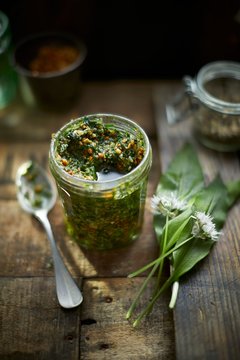 Wild garlic pesto on wood in a jar