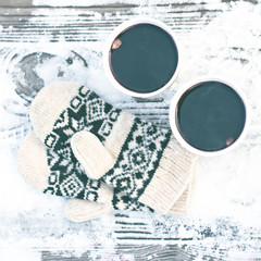 Fototapeta na wymiar paper craft glass, cup with a hot drink, coffee, cocoa, mulled wine and white and black mittens
