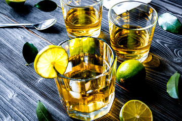 glass of whiskey on dark wooden background